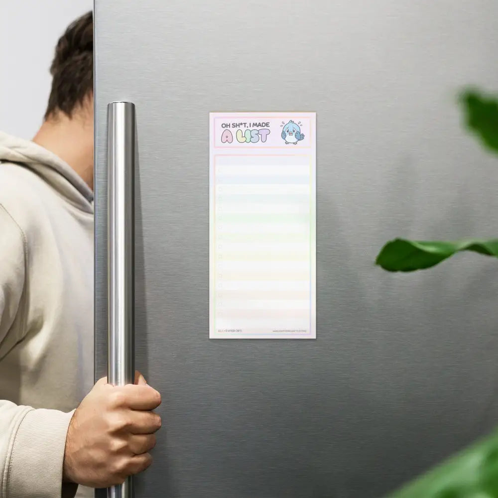 A product mockup of a notepad formatted with wide lines and faint checkboxes hanging on a stainless steel refrigerator. The title says "Oh Sh*t, I made a List". It features a panicking bluebird to the right of the title.