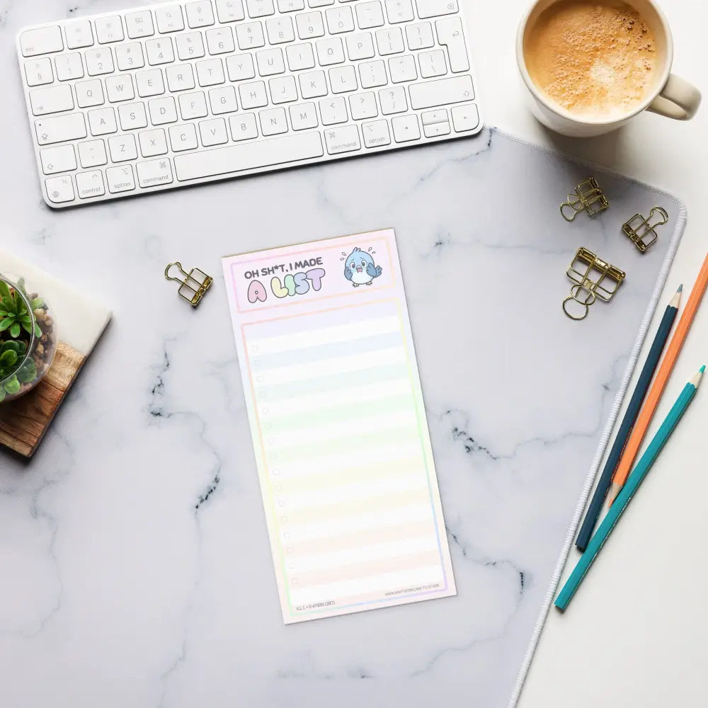 A product mockup of a notepad formatted with wide lines and faint checkboxes against a marble desk pad. The title says "Oh Sh*t, I made a List". It features a panicking bluebird to the right of the title.