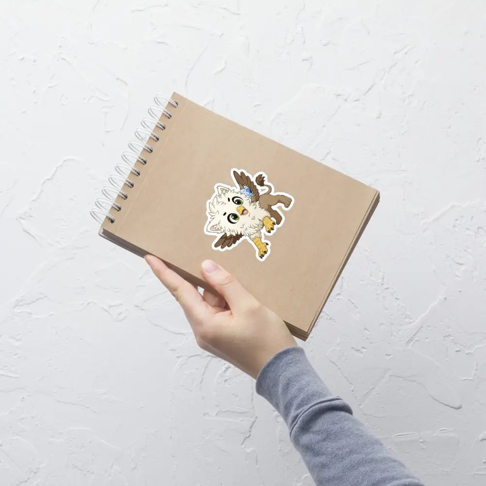 A product mockup of a 4x4" vinyl sticker on a brown notebook cover, featuring Echo the Griffin.
