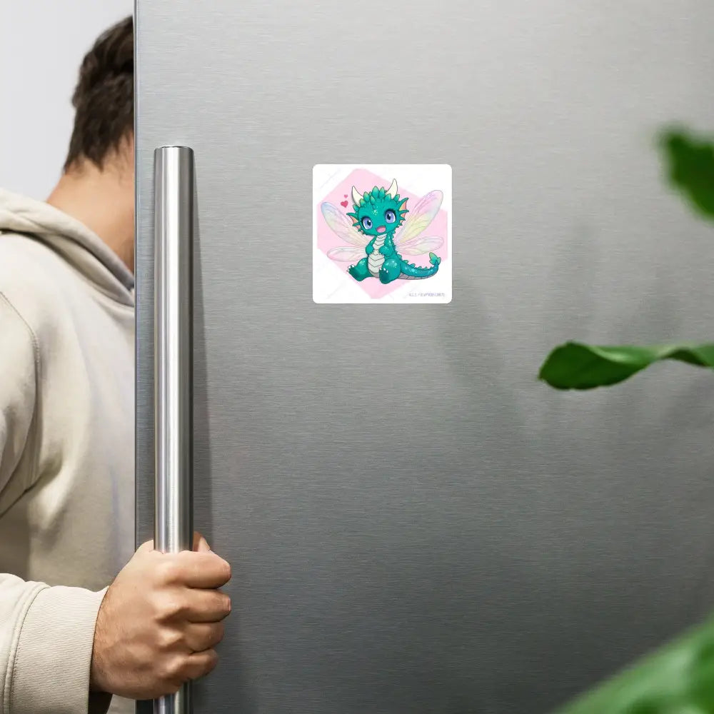 A product mockup of the 4x4" magnet featuring Tetra the Fairy Dragon hanging on a stainless steel refrigerator door