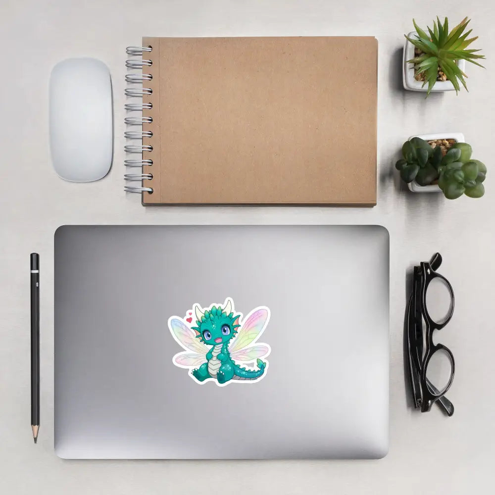 A product mockup of a 4x4" vinyl sticker on a silver laptop lid, featuring Tetra the Fairy Dragon