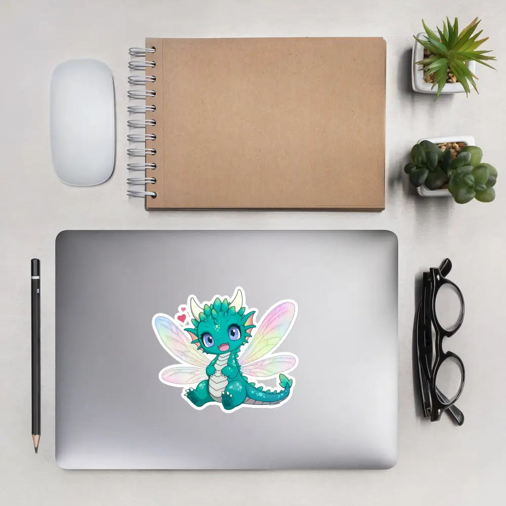 A product mockup of a 5x5" vinyl sticker on a silver laptop lid, featuring Tetra the Fairy Dragon