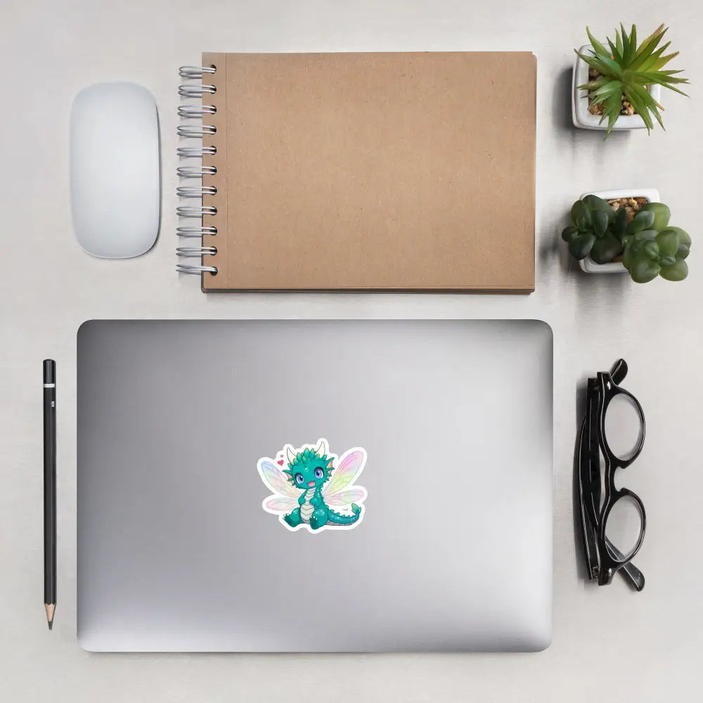 A product mockup of a 3x3" vinyl sticker on a silver laptop lid, featuring Tetra the Fairy Dragon